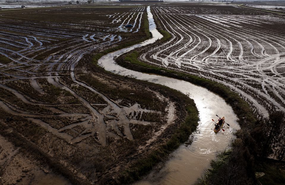 Members of the V battalion of a military emergency unit use a canoe to search the area for bodies (Emilio Morenatti/AP)