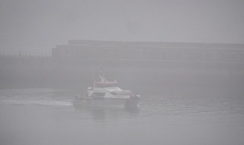 A group of people thought to be migrants are brought in to Dover, Kent, by a Border Force vessel in misty conditions (Gareth Fuller/PA)