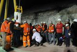 thumbnail: In this photo released by the Chilean presidential press office, Chile's President Sebastian Pinera, fourth right, applauds while the capsule with the first rescued miner Florencio Avalos comes out from the collapsed San Jose gold and copper mine where he was trapped with 32 other miners for over two months near Copiapo, Chile, early Wednesday, Oct. 13, 2010.  (AP Photo/Jose Manuel de la Maza, Chilean presidential press office)