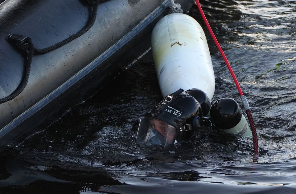 A police diver in the River Dee at Aberdeen harbour during the ongoing search for the sisters (Andrew Milligan/PA)