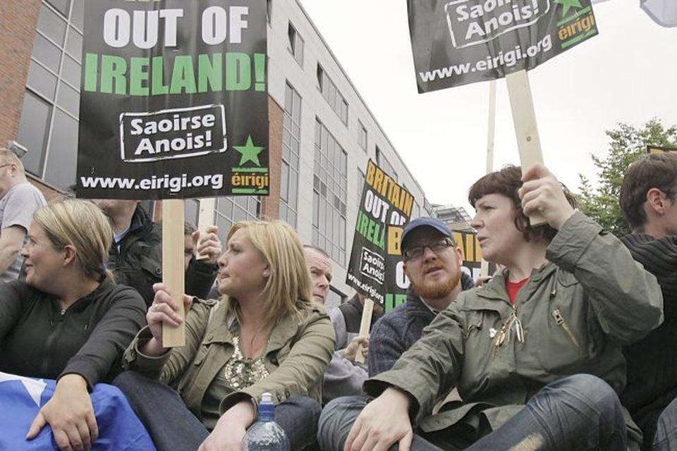 Protestors make their way down a street in Dublin after the Queen arrived in the country for a four day state visit.