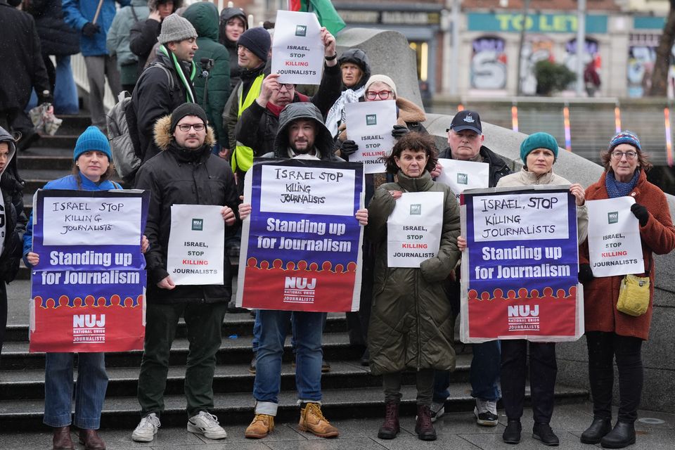 NUJ members hold a vigil on Dublin’s Ha’penny Bridge (Niall Carson/PA)