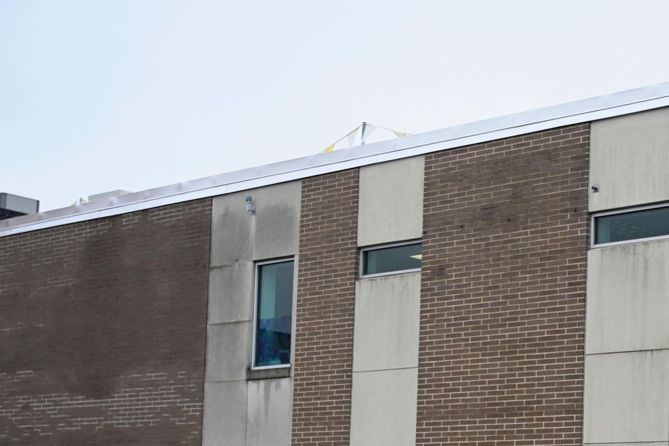 A law enforcement officer walks into the Altoona Police Department where 26-year old Luigi Mangione is being held (Benjamin B. Braun/Pittsburgh Post-Gazette via AP)