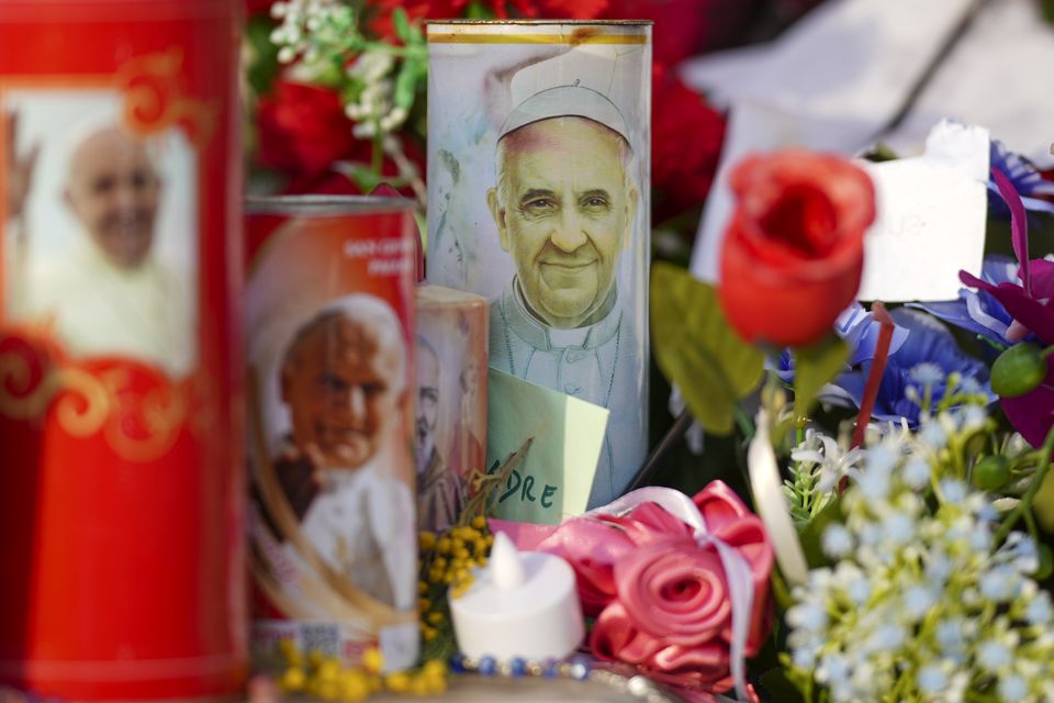 Candles and flowers for Pope Francis (Andrew Medichini/AP)