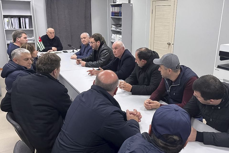 Aslan Bzhania, background second left, spoke with Abkhazian politicians (Information Centre of the President of the Republic of Abkhazia via AP)