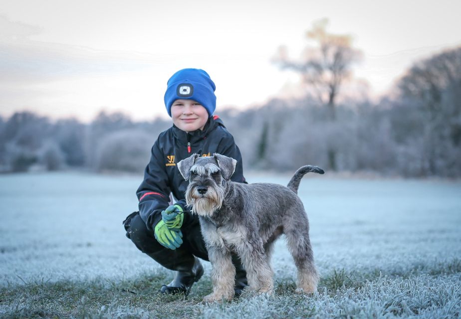 Jonny's son Noah with their miniature schnauzer Bodhi.