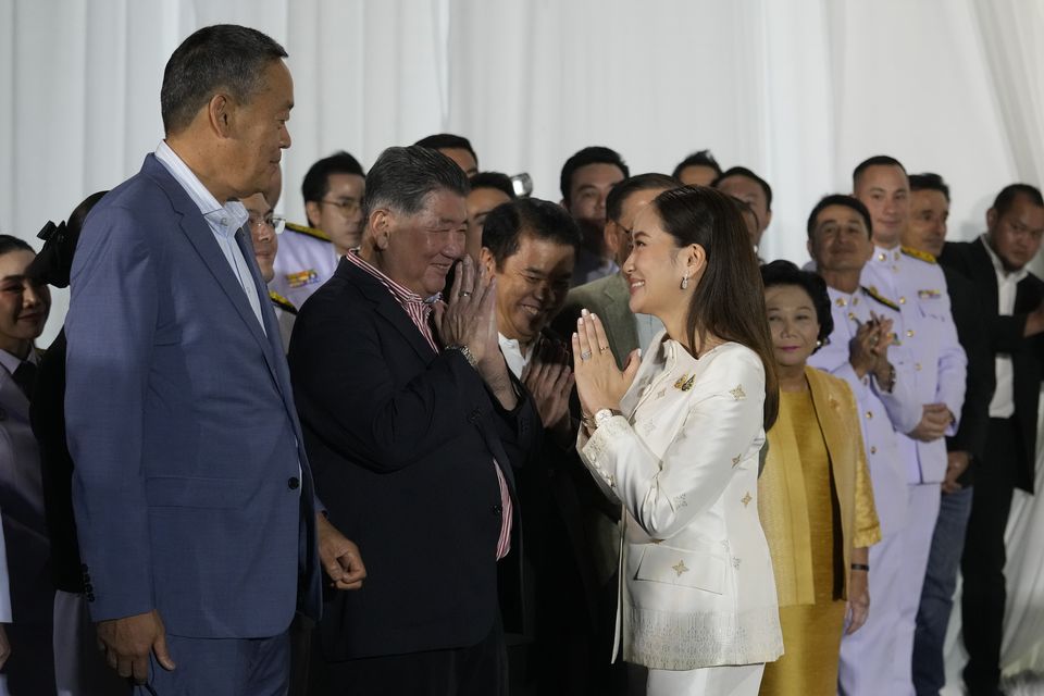 Thailand’s new Prime Minister Paetongtarn Shinawatra, right, pays respect to former Thai prime minister Srettha Thavisin (Sakchai Lalit/AP)