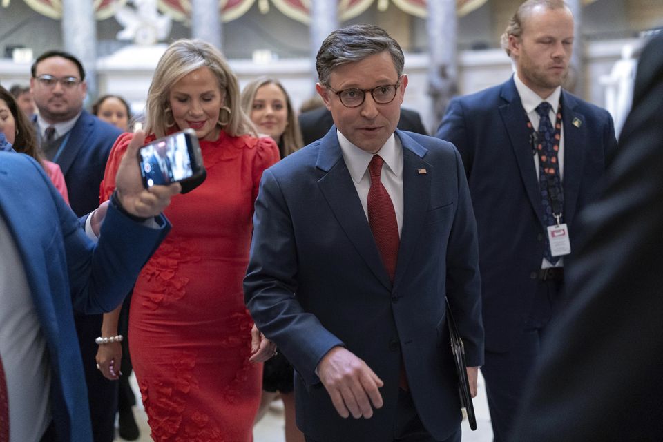 Speaker of the House Mike Johnson, accompanied by his wife Kelly Johnson, walks to the House Chamber before starting the 119th United States Congress at the Capitol in Washington (Jose Luis Magana/AP)