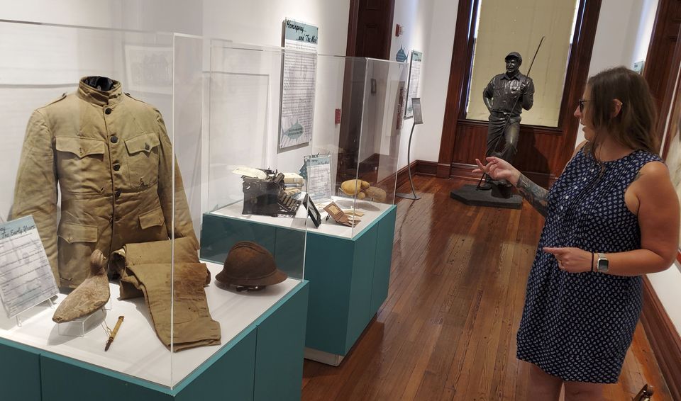 Curator Cori Convertito shows off Ernest Hemingway’s First World War ambulance driver uniform and other belongings at Key West Museum of Art & History at the Custom House in Key West (David Fischer/AP)