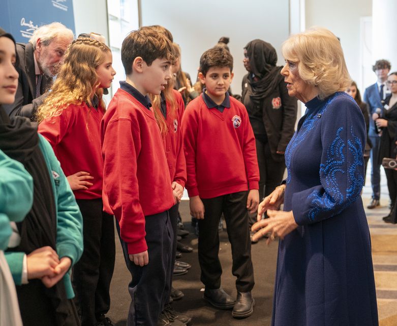 Queen Camilla speaks to children, during a reception hosted by the Anne Frank Trust to mark Holocaust Memorial Day (Arthur Edwards/The Sun/PA)