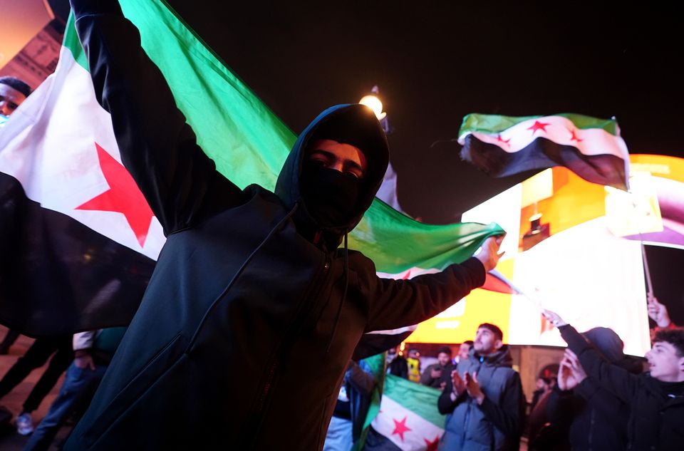 Members of the Syrian community in the UK gather at Piccadilly Circus to celebrate the fall of Bashar Assad’s government, after 13 years of civil war (James Manning/PA)