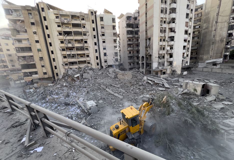 A worker uses a bulldozer to remove the rubble of a destroyed building that was hit in an Israeli airstrike on Dahiyeh (Hussein Malla/AP)