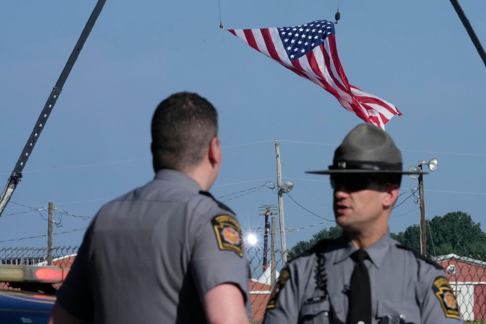 Police officers stand at a road leading to the site of the Trump rally in Butler, Pennsylvania (Sue Ogrocki/AP)