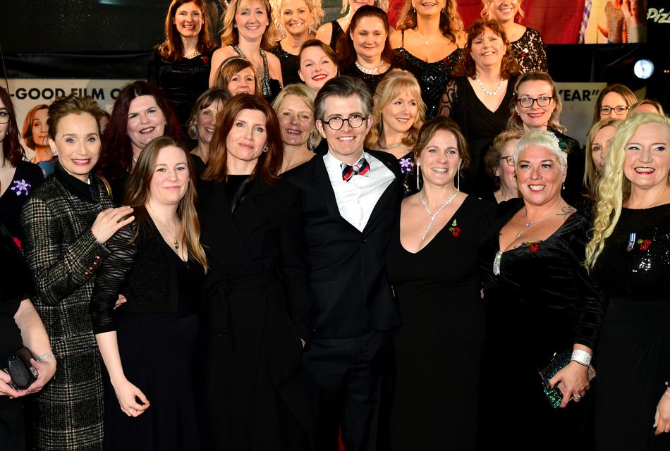 Dame Kristin Scott Thomas, Gareth Malone and Sharon Horgan with the Combined Military Wives Choir attending the premiere of the film Military Wives in 2020 (Ian West/PA)