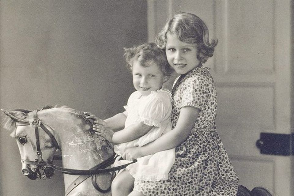 Princess Elizabeth and Princess Margaret riding a rocking horse at St. Paul's Waldenbury in August 1932