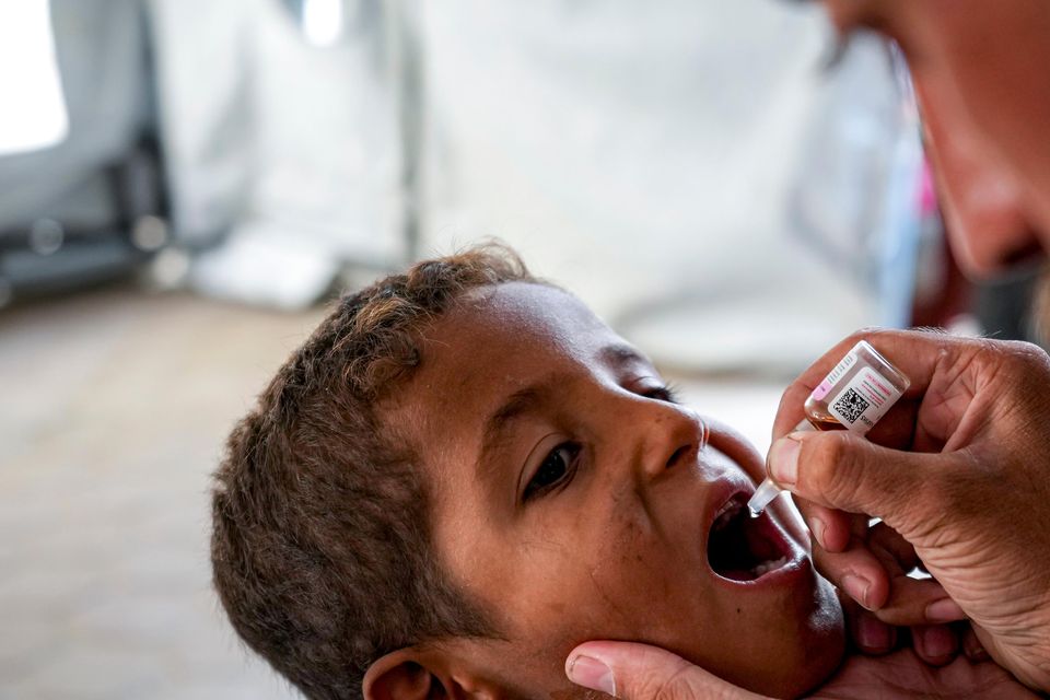 A health worker administers a polio vaccine to a child at a hospital in Deir al-Balah, central Gaza Strip (Abdel Kareem Hana/AP)