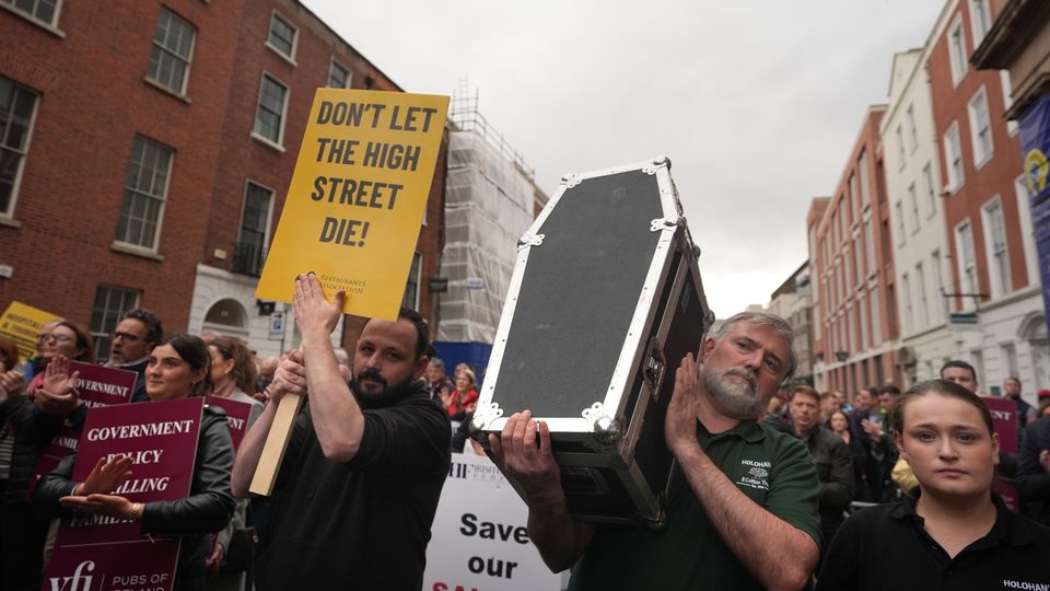 People from the hospitality and retail sectors take part in a march to Leinster House, Dublin, to highlight the high costs facing small and medium-sized businesses (Niall Carson/PA)