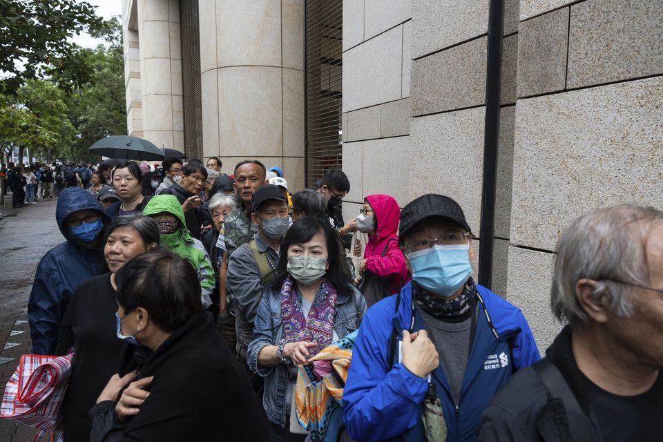 More than 200 people queued in rain and winds on Tuesday for a seat in the hearing (Chan Long Hei/AP)