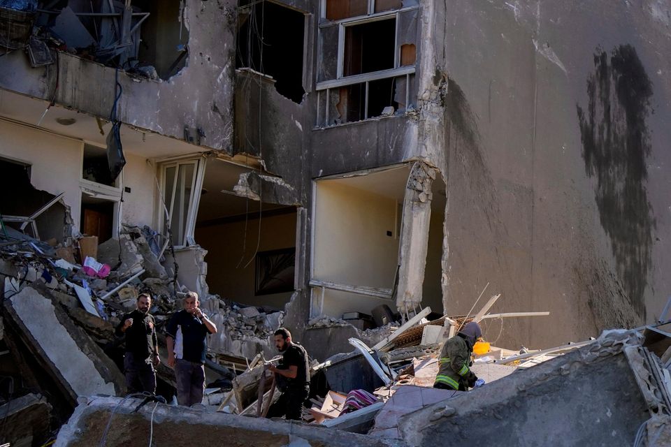 Residents check the site of an Israeli air strike in Tayouneh, Beirut, Lebanon (Hassan Ammar/AP)