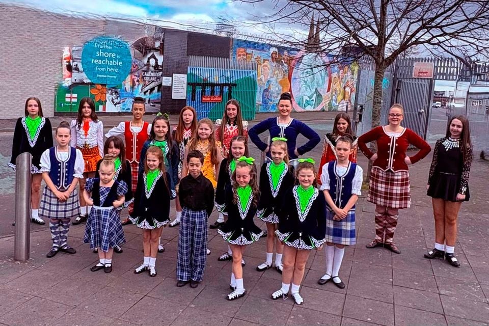 Irish dancers of the Dancing School and Scottish Dancommors of McNeill of the Sarah Graham School of Dancing Highland that is shown at the Peace doors in Northumberland in Belfast