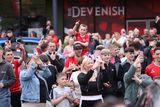 thumbnail: Clifonville fans wait to catch a glimpse of Irish Cup winners Cliftonville Football players as they arrive at the Devinish bar on an open top bus to meets supporters.  Picture by Peter Morrison