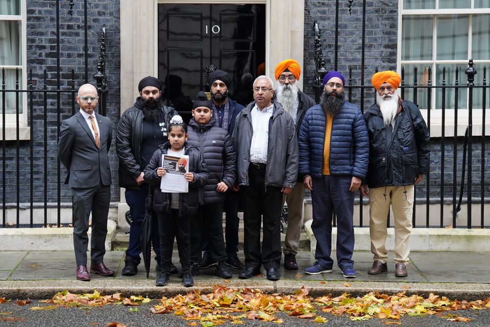 Members of the Free Jaggi Now Campaign hand a petition in to 10 Downing Street to mark five years of detention for Jagtar Singh Johal, or Jaggi, in 2022 (James Manning/PA)