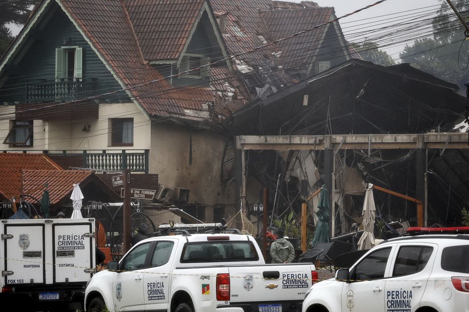 Police cordon off houses that were hit by a plane in Gramado, Rio Grande do Sul State, Brazil (Mateus Bruxel, Agencia RBS/AP)