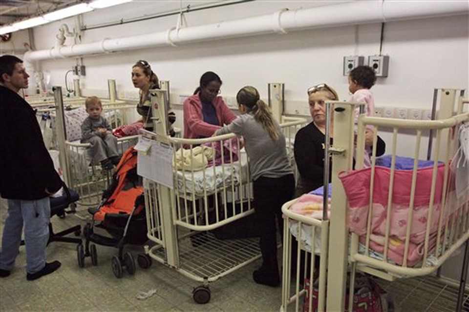 Israeli hospital patients and their families wait in a bomb shelter in Ashkelon Barzily hospital, southern Israel, Saturday, Dec. 27, 2008. Israeli warplanes retaliating for rocket fire from the Gaza Strip pounded dozens of security compounds across the Hamas-ruled territory in unprecedented waves of airstrikes Saturday, killing more than 200 people and wounding nearly 400 in the single bloodiest day of fighting in years. (AP Photo/Tsafrir Abayov)