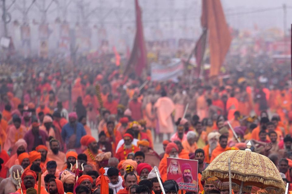 Hindu ascetics arrive for a ritualistic dip at the confluence of the Rivers Ganges, Yamuna and mythical Saraswati during the Maha Kumbh festival in Prayagraj, India (Rajesh Kumar Singh/AP)