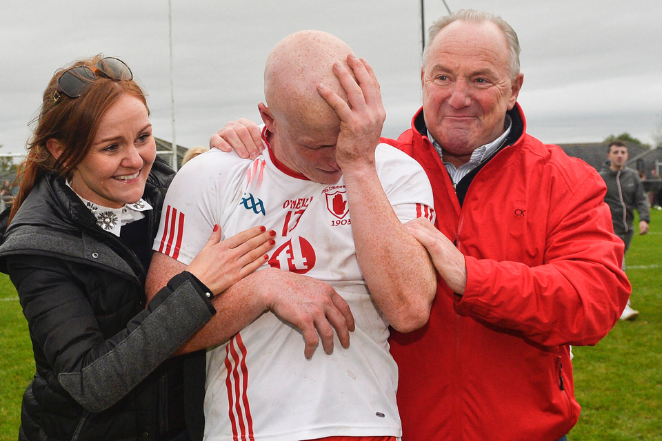 Emotional: Lamh Dhearg’s Paddy Cunningham is congratulated by his wife Claire and his father Paddy after winning the Antrim Football final at his sixth attempt