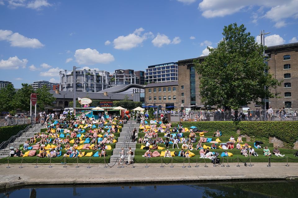 People enjoying the warm weather in Granary Square, London (Jonathan Brady/PA)