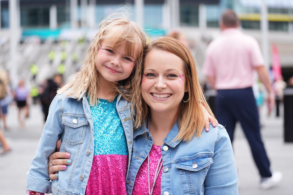 Violet Morris, five, and her mother Sarah, 35, will be among the fans lapping up Swift’s set, which spans three-and-a-half hours (James Manning/PA)