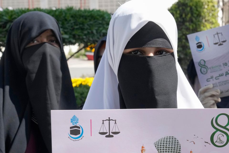 Supporters of the Jamaat-e-Islami party in Lahore, Pakistan, hold placards in support of the women of Gaza (KM Chaudary/AP)