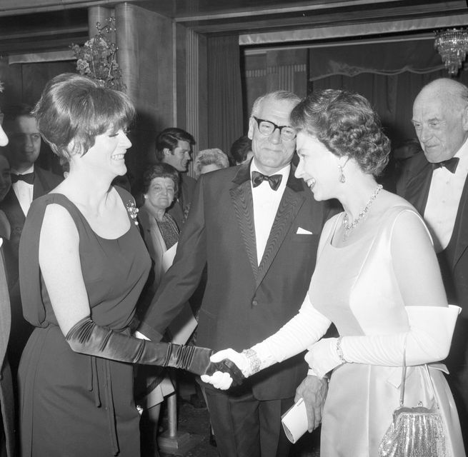 Queen Elizabeth II being presented to Dame Maggie Smith by Lord Laurence Olivier (PA)