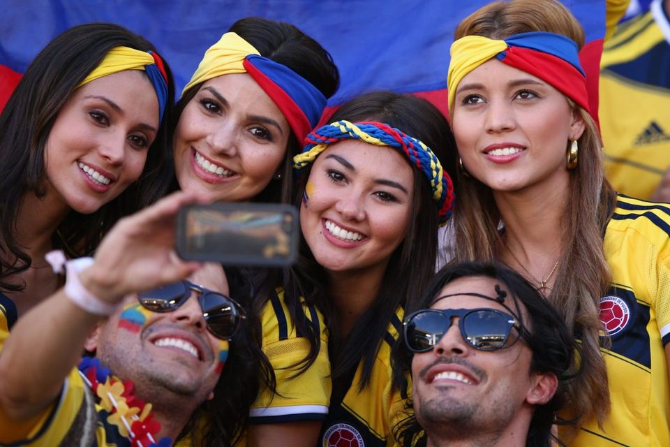 he beautiful game - football fans from around the world -  Colombia fans pose for a photo during the 2014 FIFA World Cup Brazil Group C match between Japan and Colombia at Arena Pantanal on June 24, 2014 in Cuiaba, Brazil.  (Photo by Adam Pretty/Getty Images)