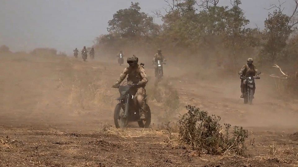 Russian marine assault team members riding motorcycles towards a Ukrainian position at an undisclosed location (Russian Defence Ministry Press Service photo via AP)