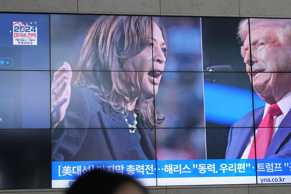 A screens shows images Kamala Harris and Donald Trump during a news programme in South Korea (Lee Jin-man/AP)