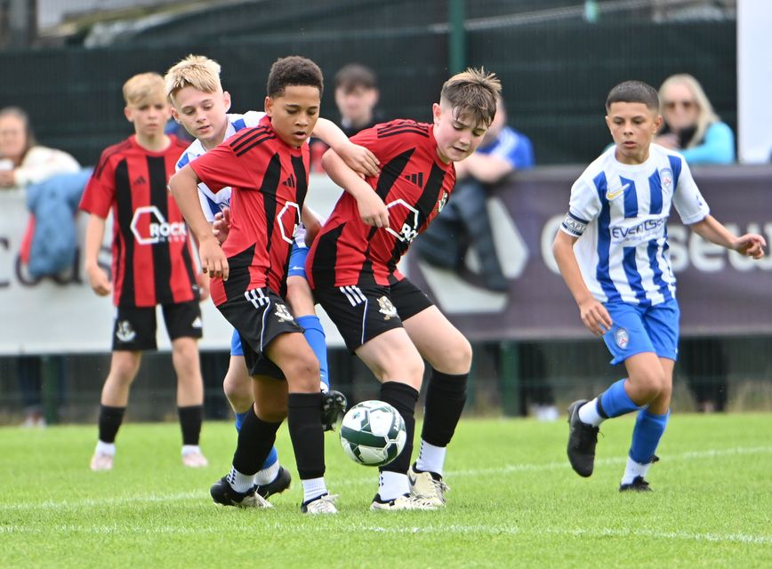 Crusaders players Daniel Clarke and Cruz Devlin-Amoh in action with Coleraine's Archie Bowles in Bushmills