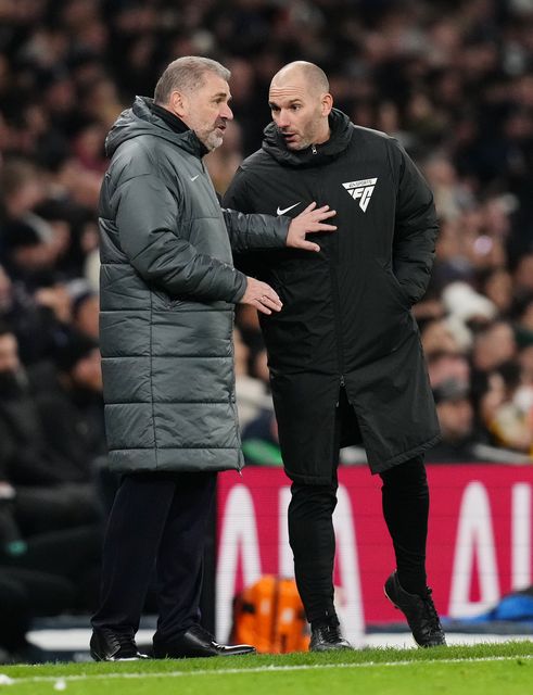 Tottenham manager Ange Postecoglou makes his point to fourth official Tim Robinson (PA)