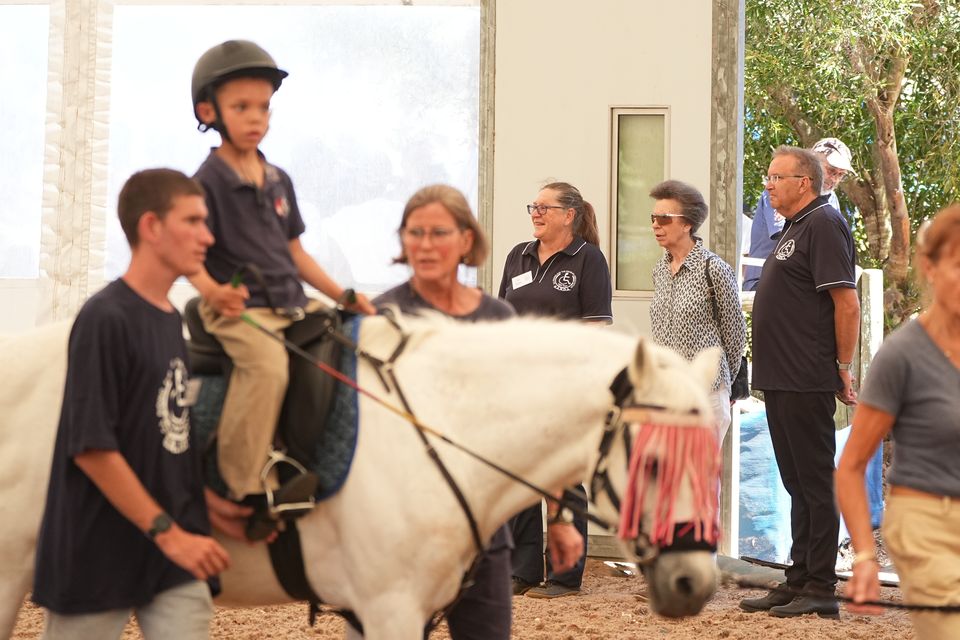 The Princess Royal views a riding lesson during a visit to the South African Riding School for Disabled Association while on her trip to South Africa (Aaron Chown/PA)