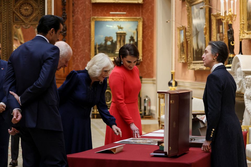 The King and Queen with the Emir of Qatar Sheikh Tamim bin Hamad Al Thani (left) and his wife Sheikha Jawaher (right) view a display of Qatari items from the Royal Collection at Buckingham Palace (Mina Kim/PA)