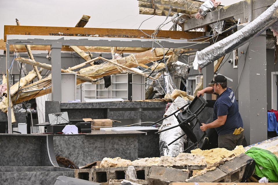 Dustin Halcom of the Cord Fire Department helps salvage what is left of the Walling Drug store in Cave City, Arkansas (Staci Vandagriff/Arkansas Democrat-Gazette/AP)