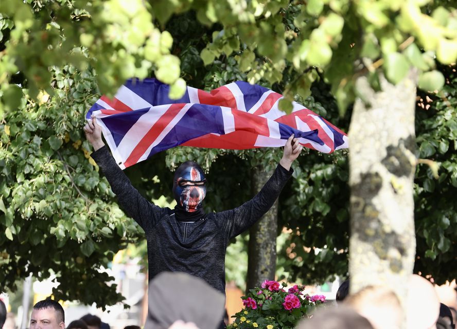 A man with a Union Jack flag in Belfast city centre