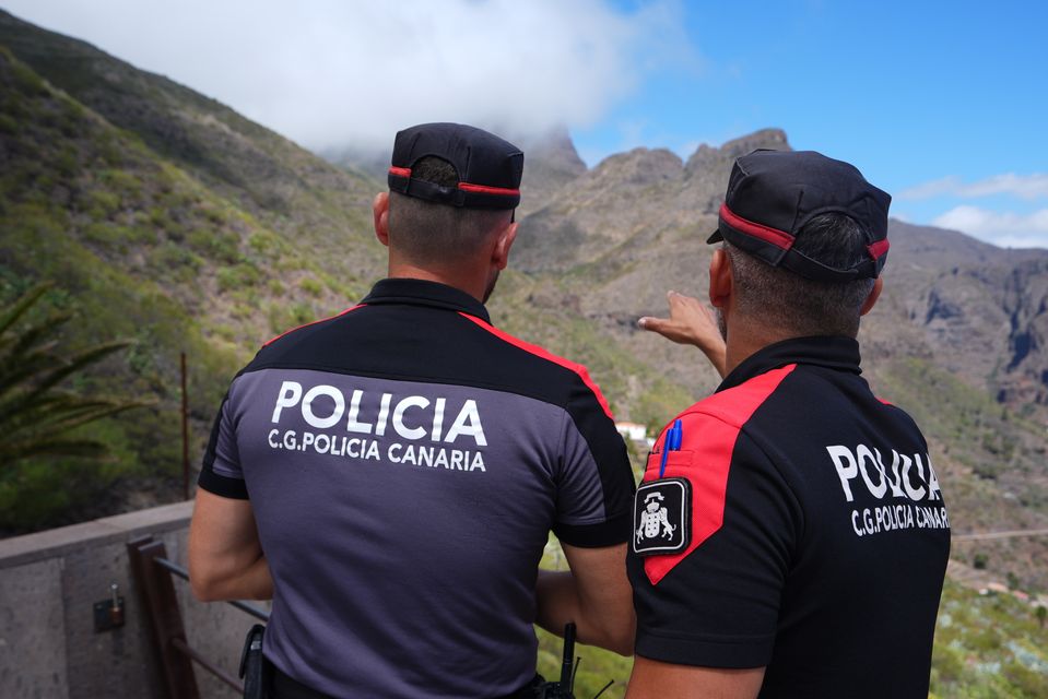 Police officers overlook the village of Masca, Tenerife, during the search for missing British teenager Jay Slater, 19, from Oswaldtwistle, Lancashire (James Manning/PA)