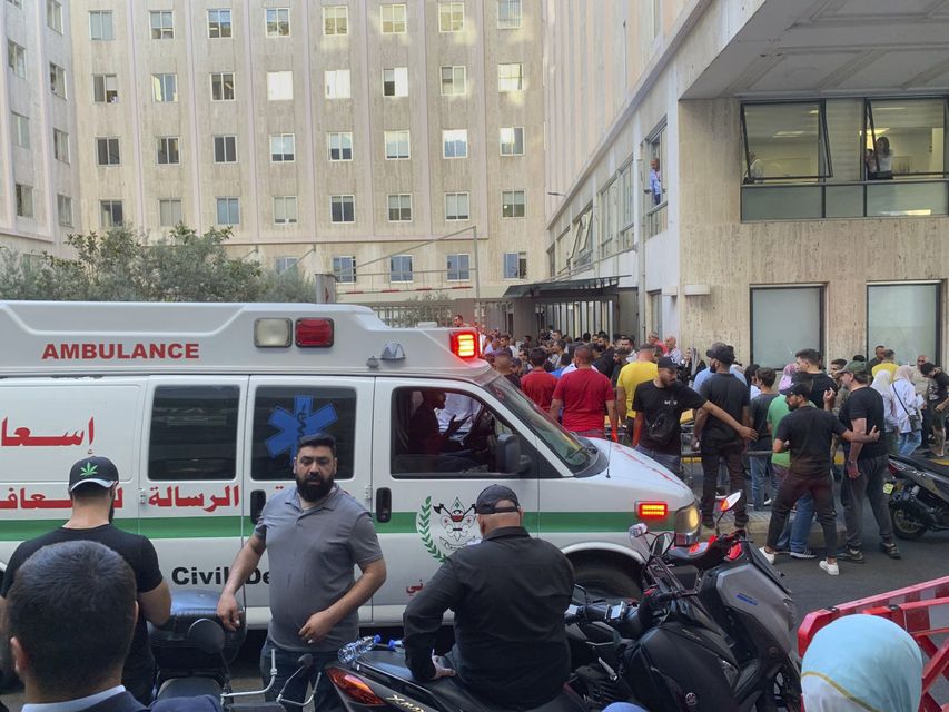 People gather outside the American University hospital after the arrival of several men who were wounded by exploding handheld pagers in Beirut (AP Photo/Bassam Masri)