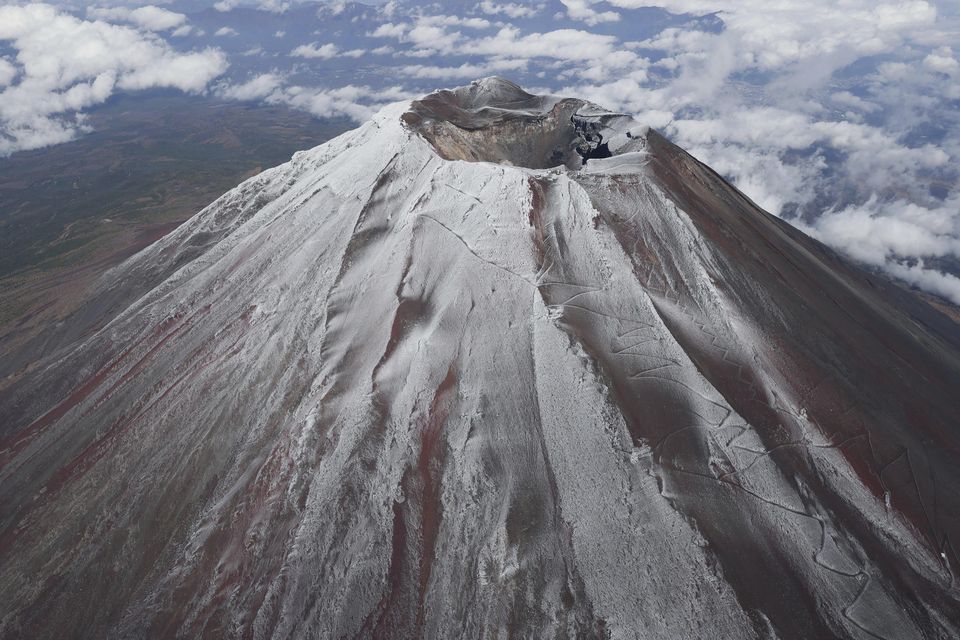 Mount Fuji is capped with snow on Wednesday (Kyodo News/AP)