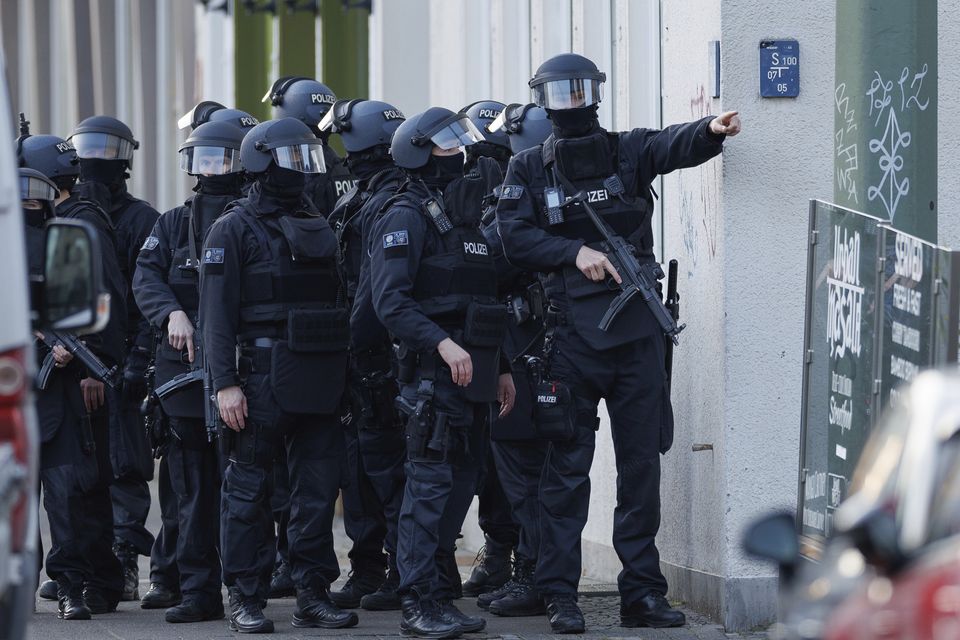 Armed police officers secure a street in front of the district court in the city centre after an incident in Bielefeld, Germany (AP)