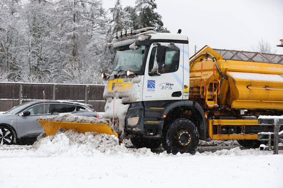 A snow plough and gritter clears snow on the M80 near Castlecary (Steve Welsh/PA)