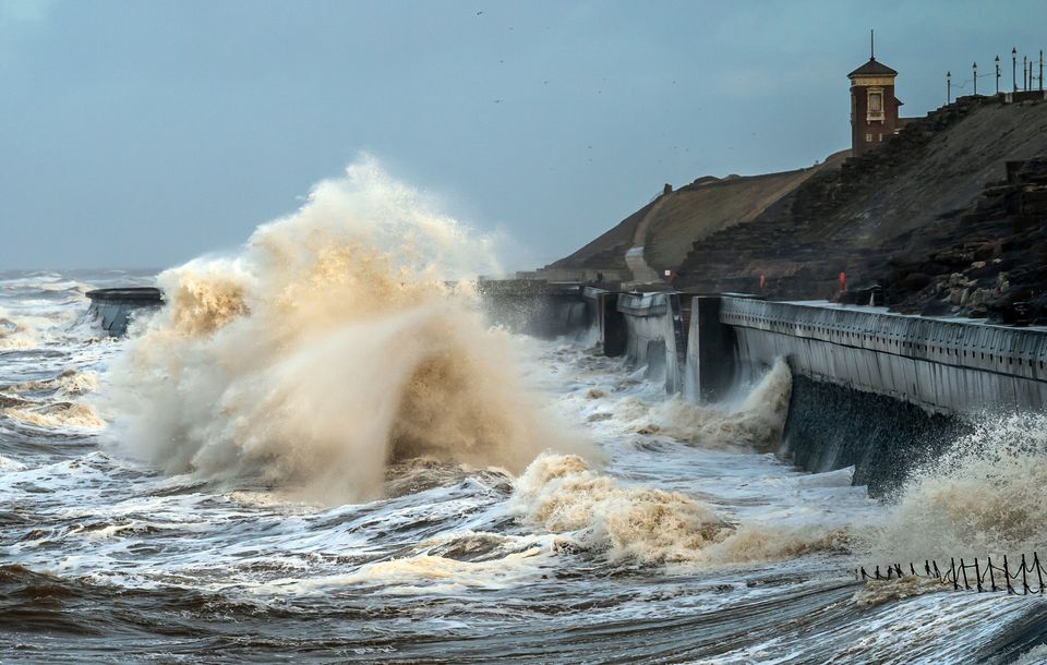 Waves break on the seafront in Blackpool as Storm Isha brought disruption to the electricity and transport networks across the UK in January (Danny Lawson/PA)