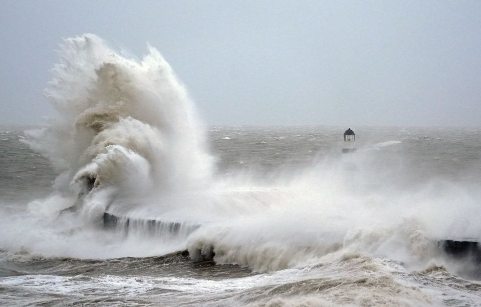 Waves crash against the lighthouse in Seaham Harbour, County Durham (Owen Humphreys/PA)